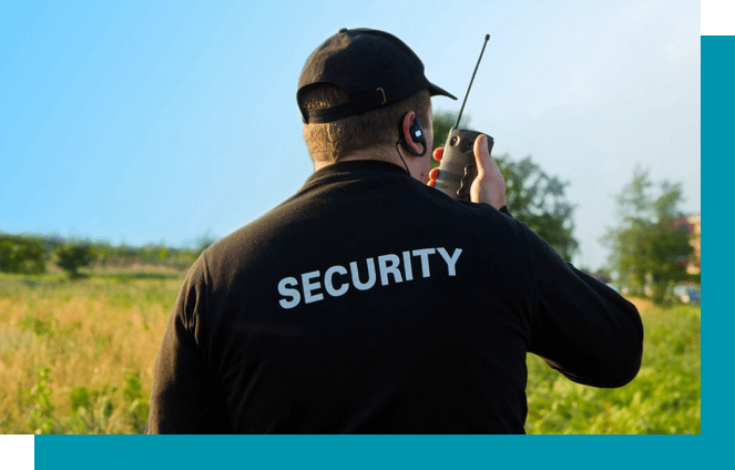 A man in black shirt holding a walkie talkie.