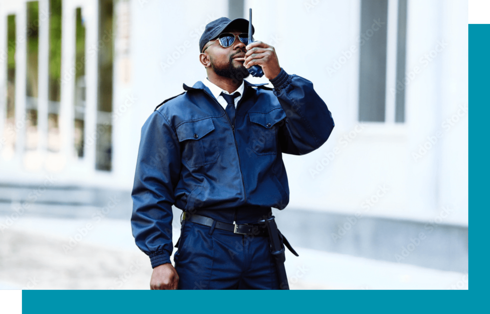 A man in blue uniform holding a walkie talkie.